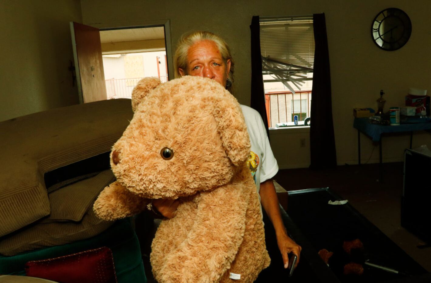 Refugio Apartments resident Loretta Capistran holds the teddy bear that was in the closet...