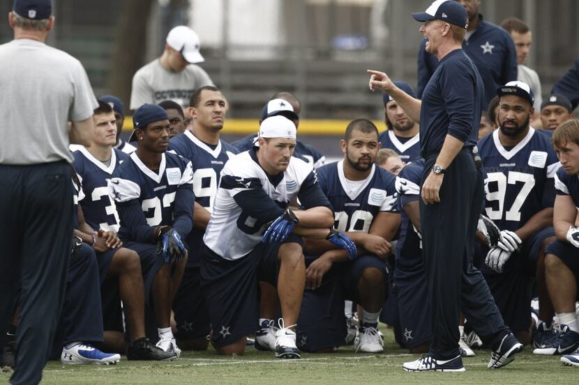 Dallas Cowboys coach Jason Garrett, right, talks to players at NFL football training camp on...