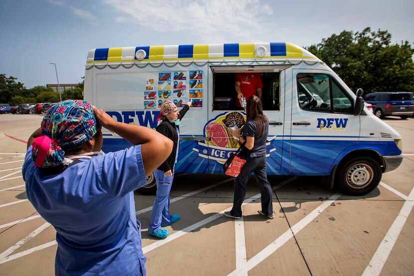 Key-Whitman Eye Center staff take a break to visit an ice cream truck brought in to treat...