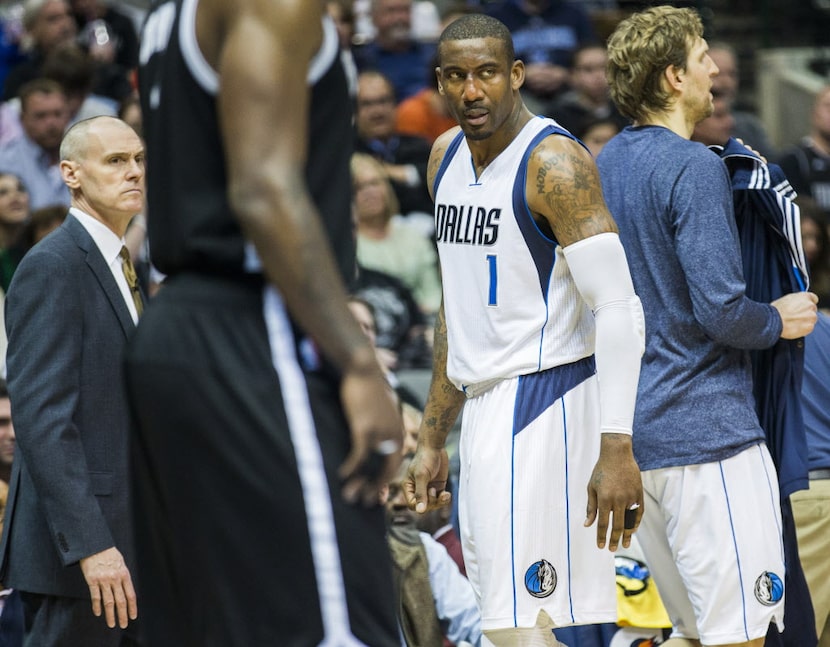 Dallas Mavericks head coach Rick Carlisle, left, and Dallas Mavericks center Amar'e...