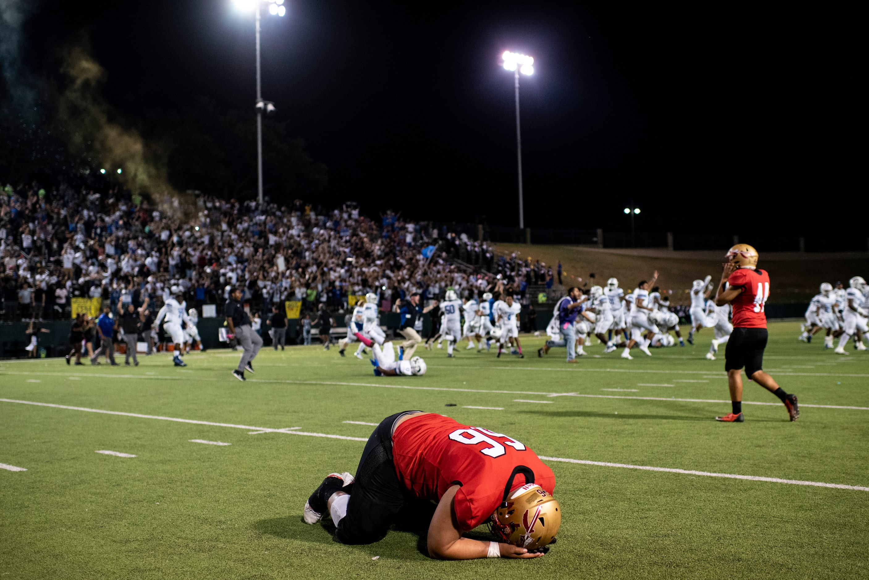 South Grand Prairie senior John Ludwig (66) puts his head down on the field as the final...