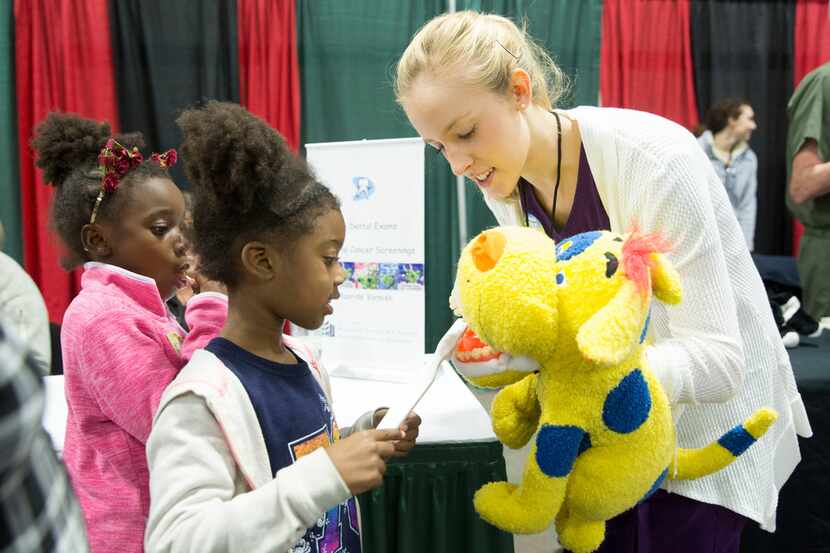 Taylor Carter, 6, practiced brushing teeth on a puppet at the 2017 KwanzaaFest.