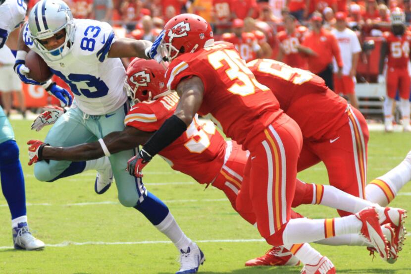 Dallas Cowboys wide receiver Terrance Williams (83) is brought down by a trio of Kansas City...