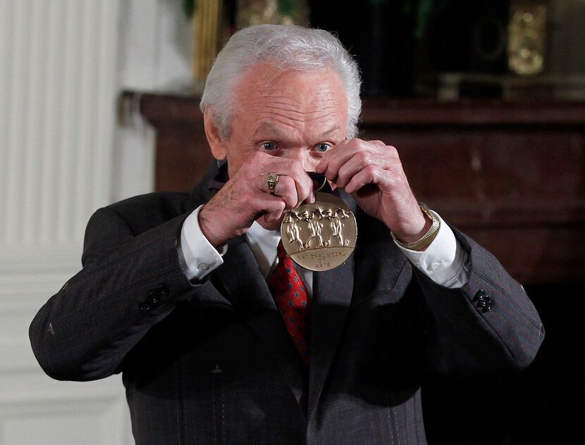 Mel Tillis holds up his 2011 National Medal of the Arts after it was presented to him by...