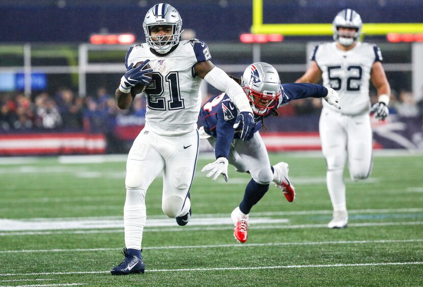 Dallas Cowboys running back Ezekiel Elliott (21) makes a break away from New England...