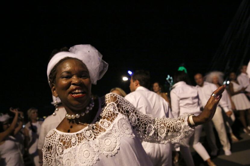 Beverly Carter dances with others during the inaugural Diner en Blanc Dallas on the...