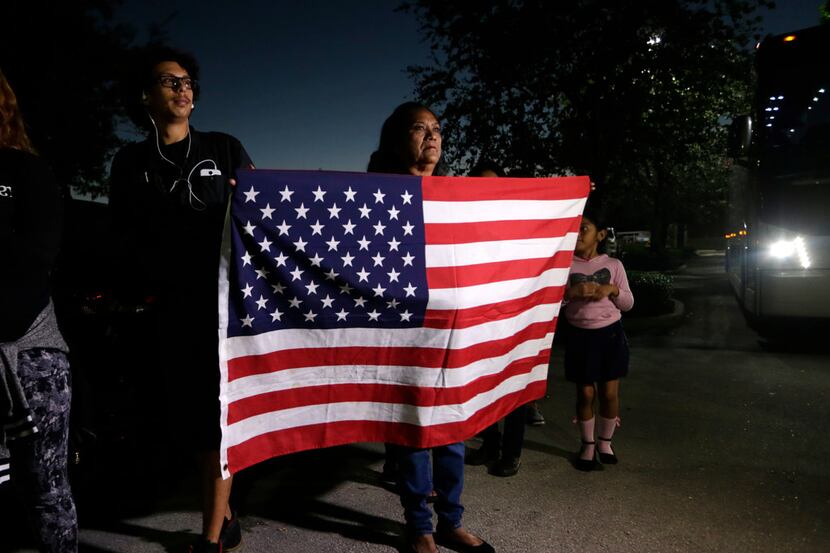 Antonia Catalon holds an American flag during a rally in support of immigrants who came into...