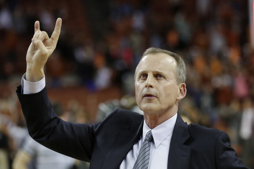 Texas coach Rick Barnes holds up the Hook 'em Horns sign after an NCAA college basketball...