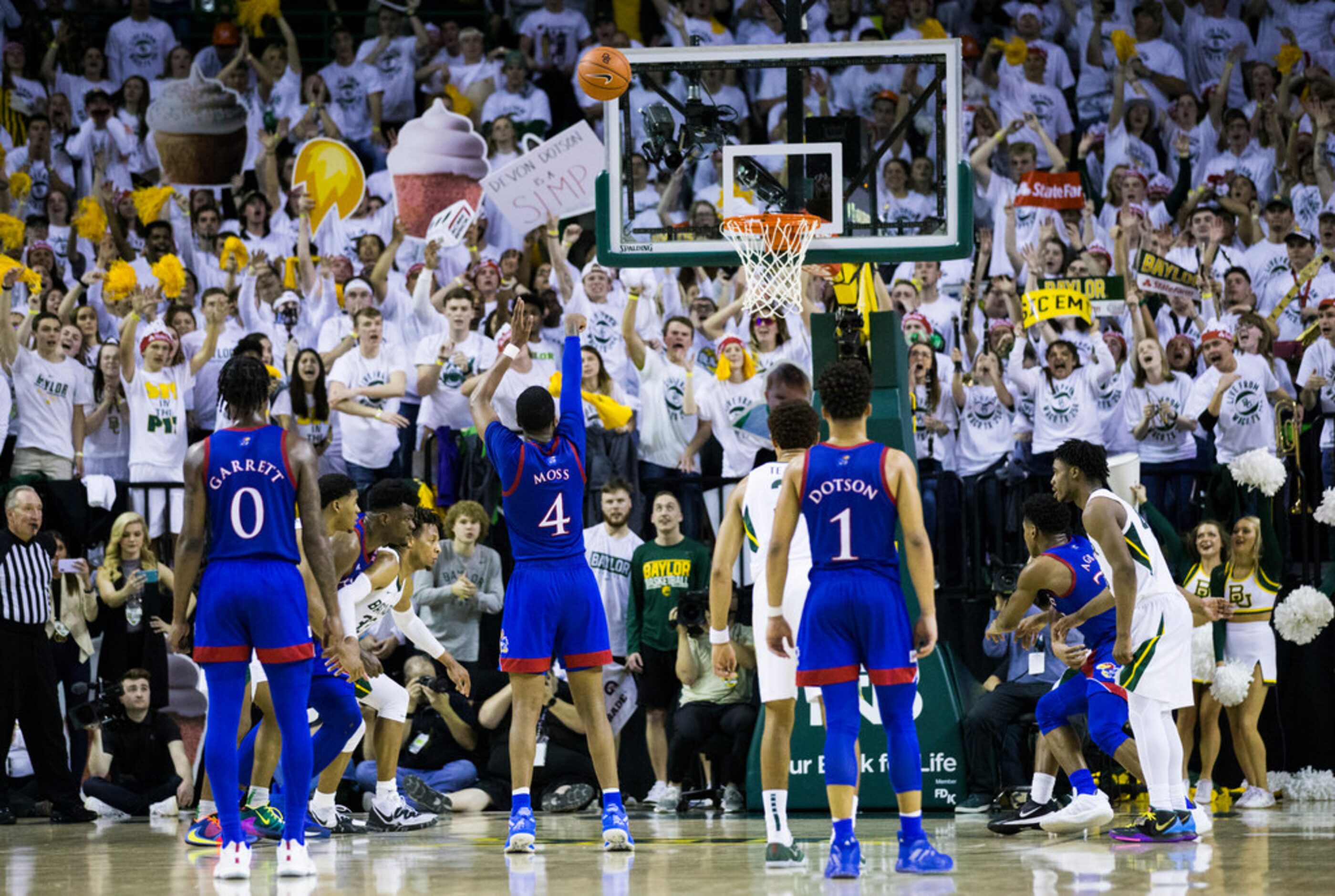 Kansas Jayhawks guard Isaiah Moss (4) makes a penalty shot to narrow the score to a three...