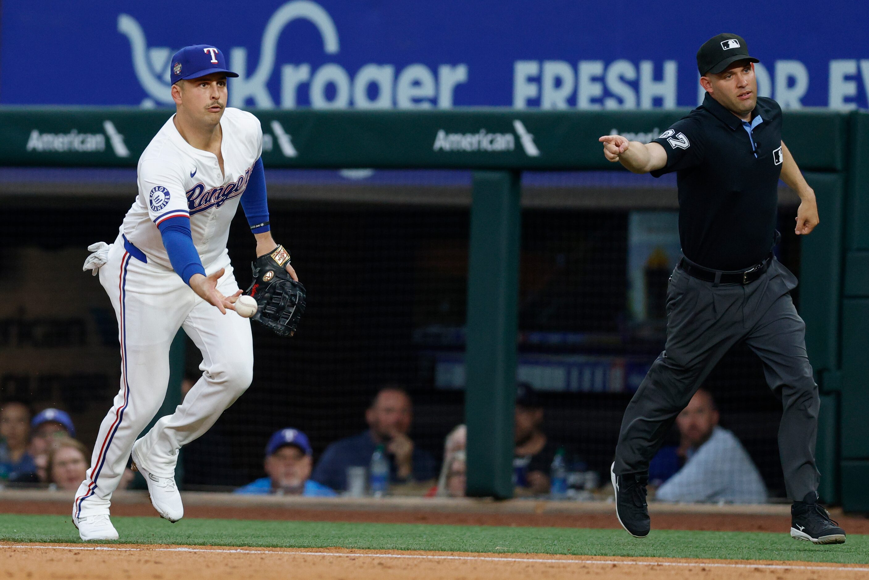 Texas Rangers first baseman Nathaniel Lowe (30) flips the ball to starting pitcher Dane...