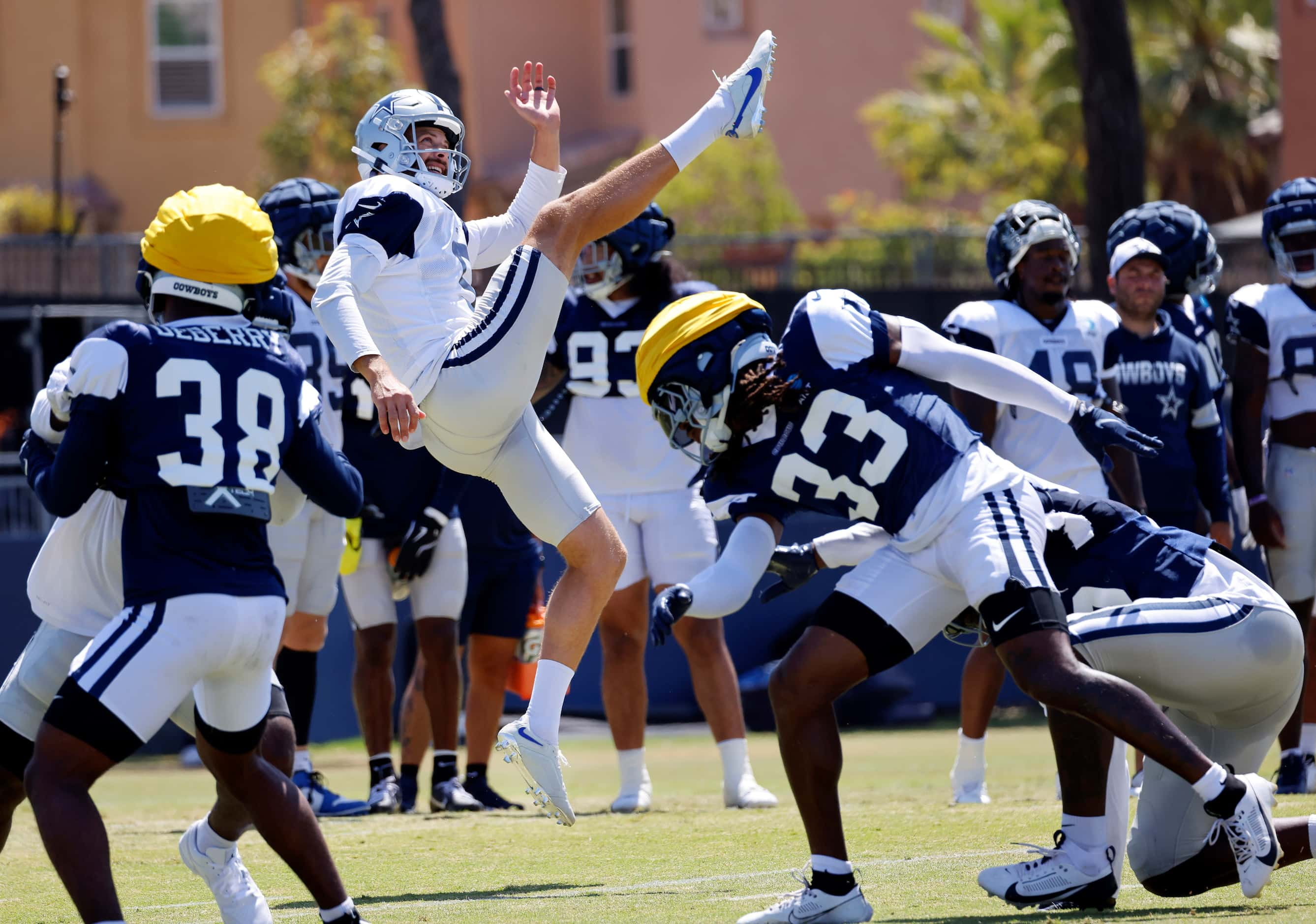 Dallas Cowboys punter Bryan Anger (5) kicks the ball during special teams plays at training...