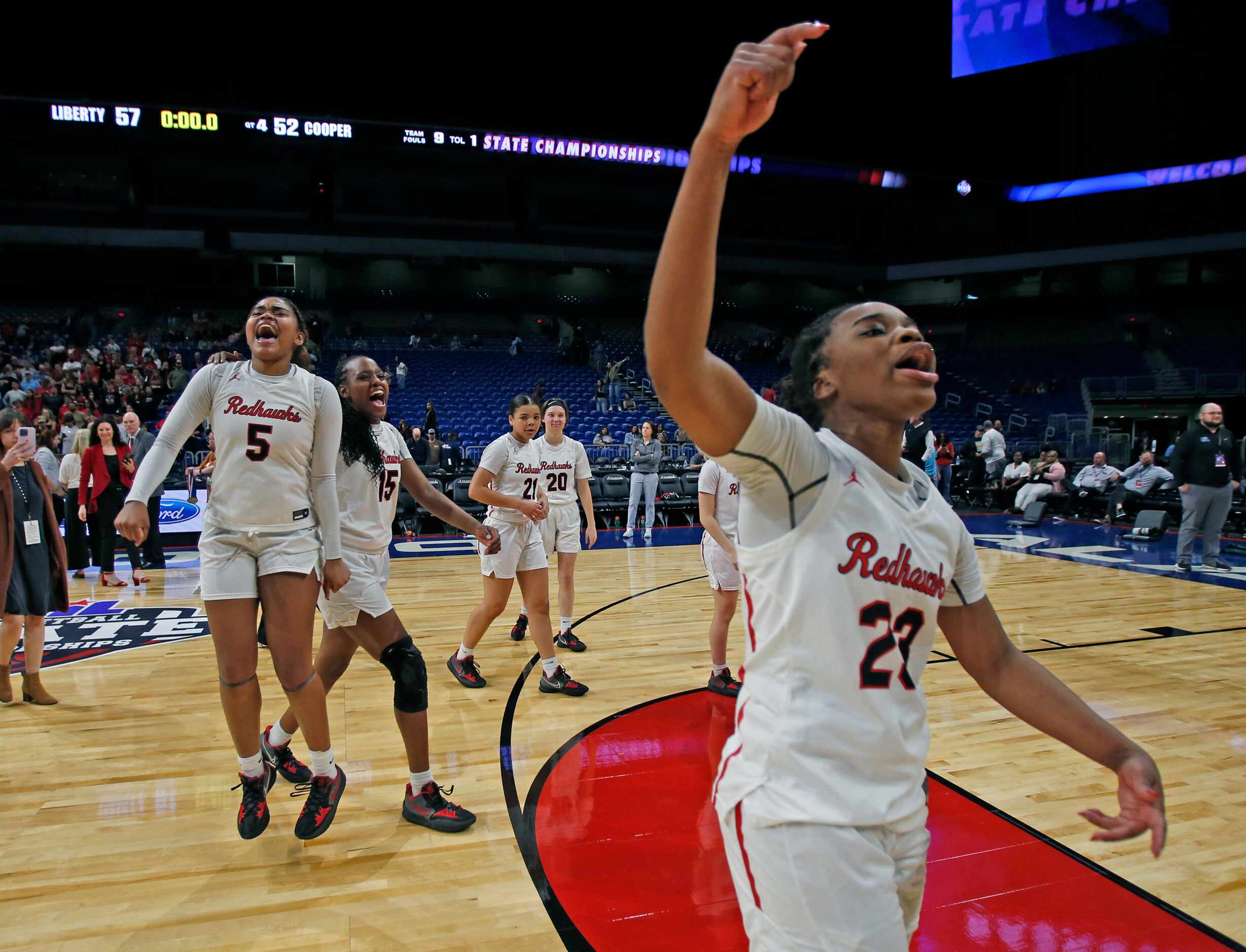 Frisco Liberty Journee Harris (23) joins Frisco Liberty Keyera Roseby (5) and the rest of...