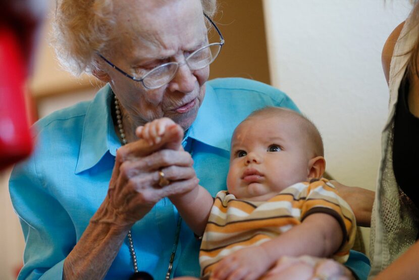 Lois Kreger plays with great-great-great-grandson Eli Wall during her birthday party in...