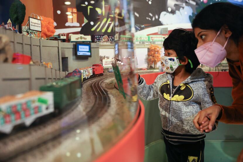 Piyusha Patel and Dax Patel, 3, take a look at The Trains at NorthPark, a display benefiting...
