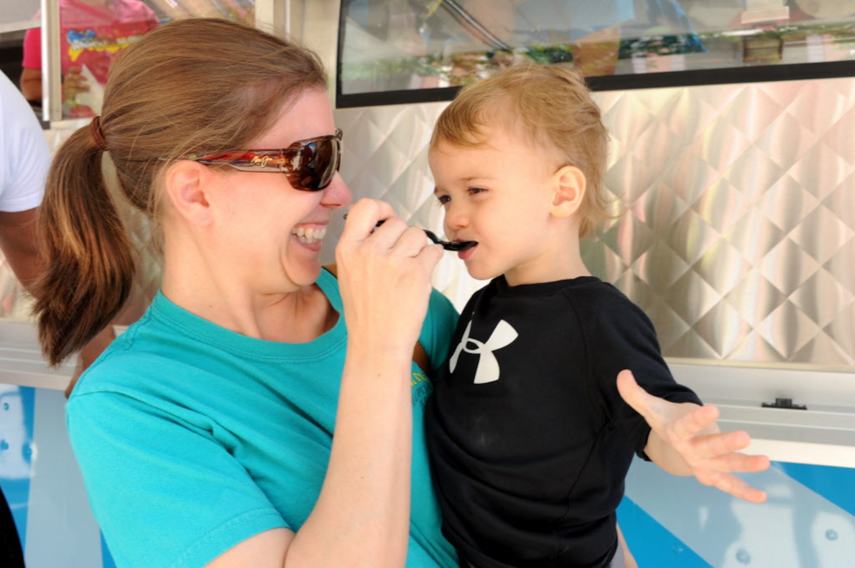 Bobbi Skorey feeds ice cream to her two-year-old son Collin from the Old Fashioned Ice Cream...