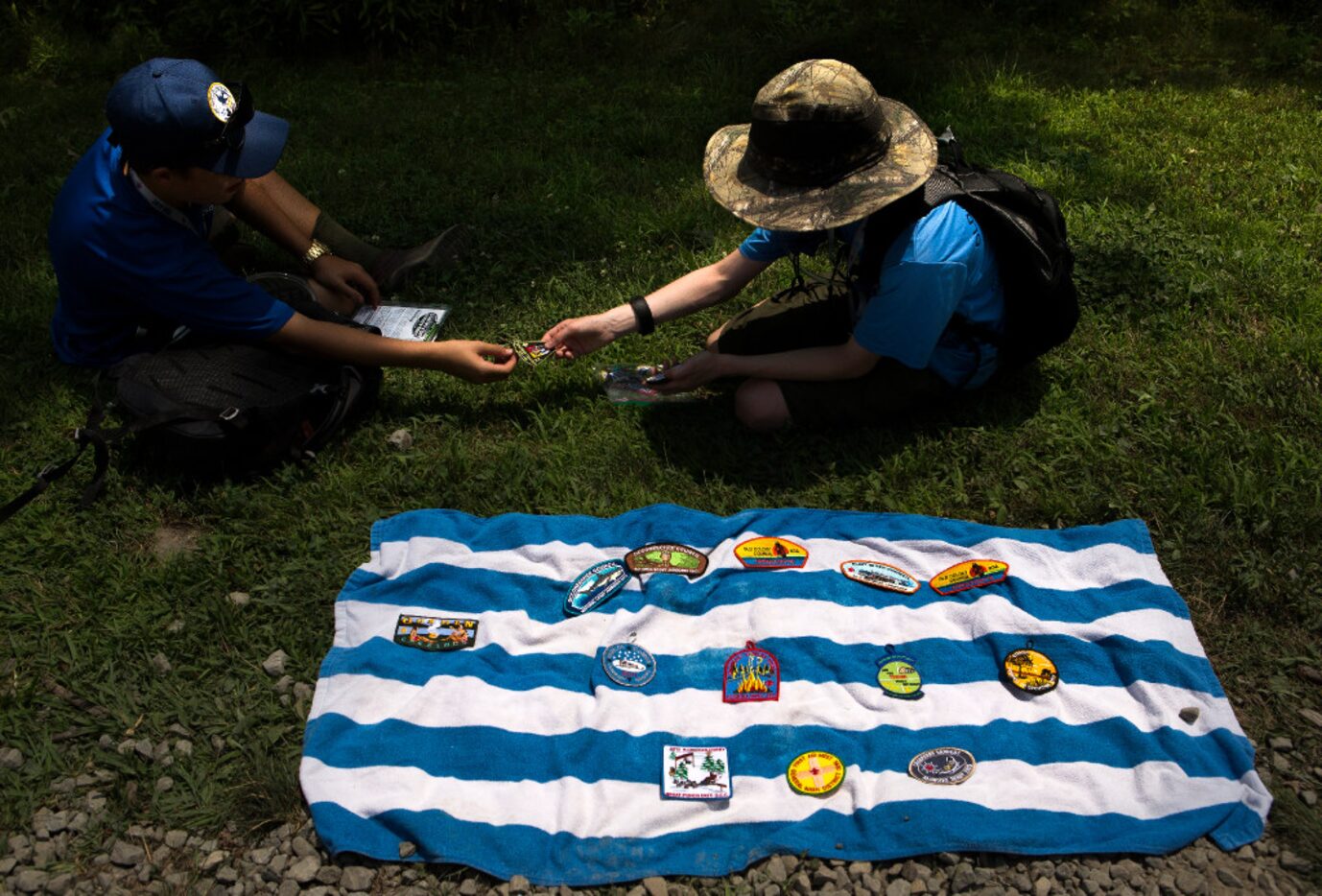 Scouts Jaiden Huntley (left) and Harrison Markwell seal a patch trading deal during the...