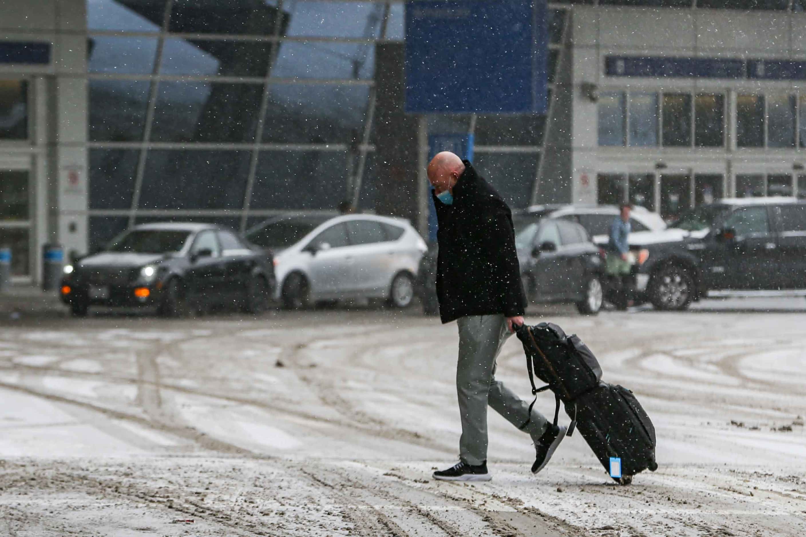 Snow, ice decend over DFW International Airport as American cancel hundreds of flights in...
