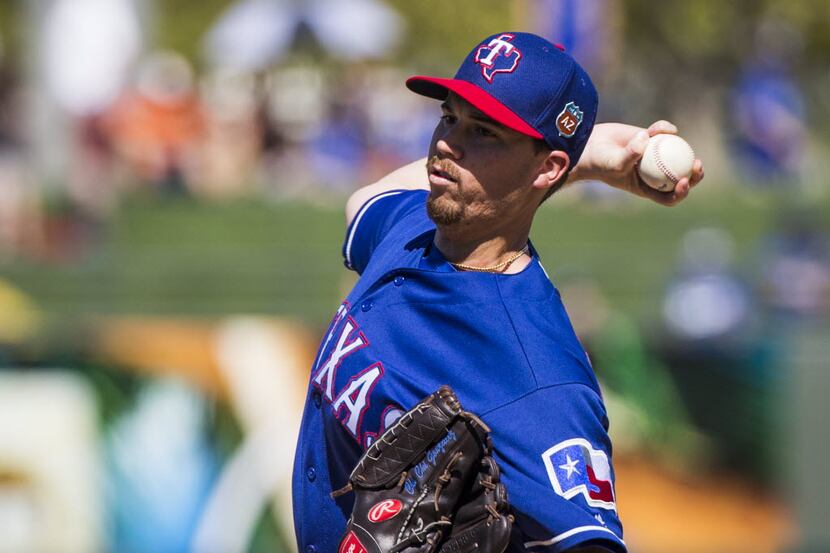 Texas Rangers pitcher Chi Chi Gonzalez pitches during a spring training game against the Los...