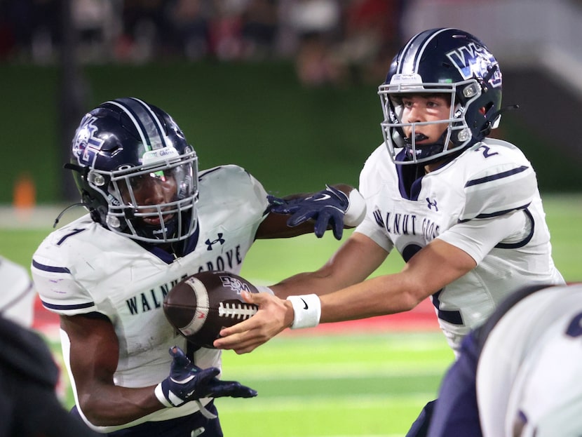 Walnut Grove player #2 Hayes Hackney hands off to player #1 Cam Newton during the Prosper...