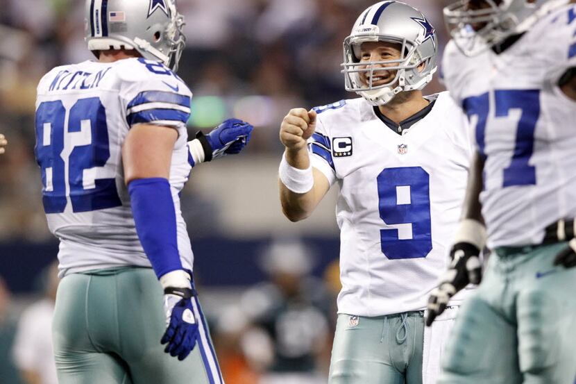 Dallas Cowboys quarterback Tony Romo (9) is all smiles with Dallas Cowboys tight end Jason...