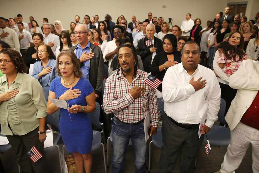 People participated in a ceremony to become American citizens during a U.S. Citizenship &...