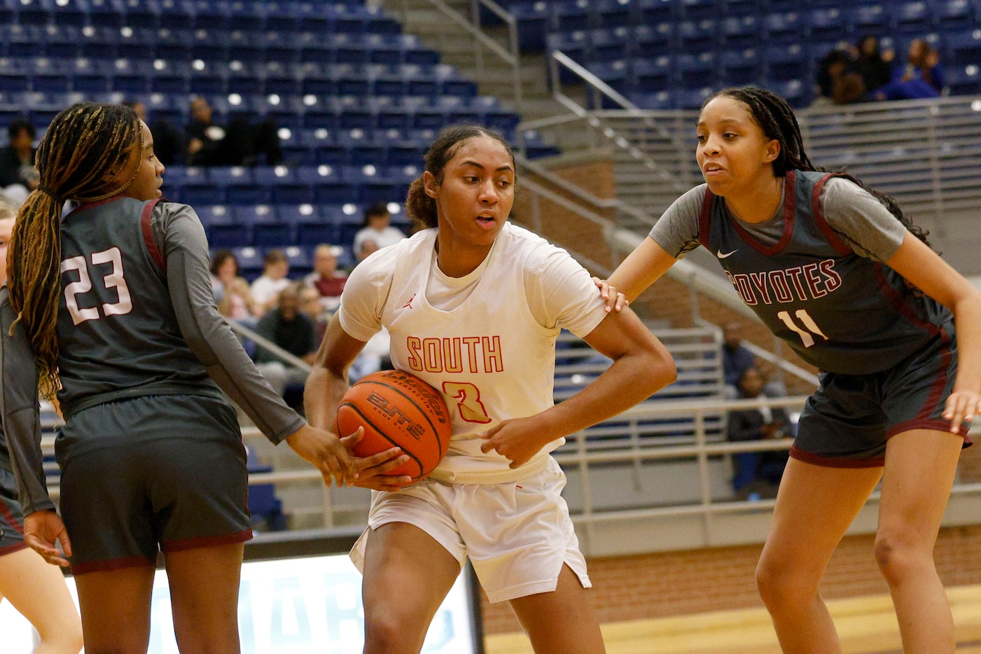 South Grand Prairie's Taylor Barnes (3) keeps the ball away from Frisco Heritage's Tatiyana...