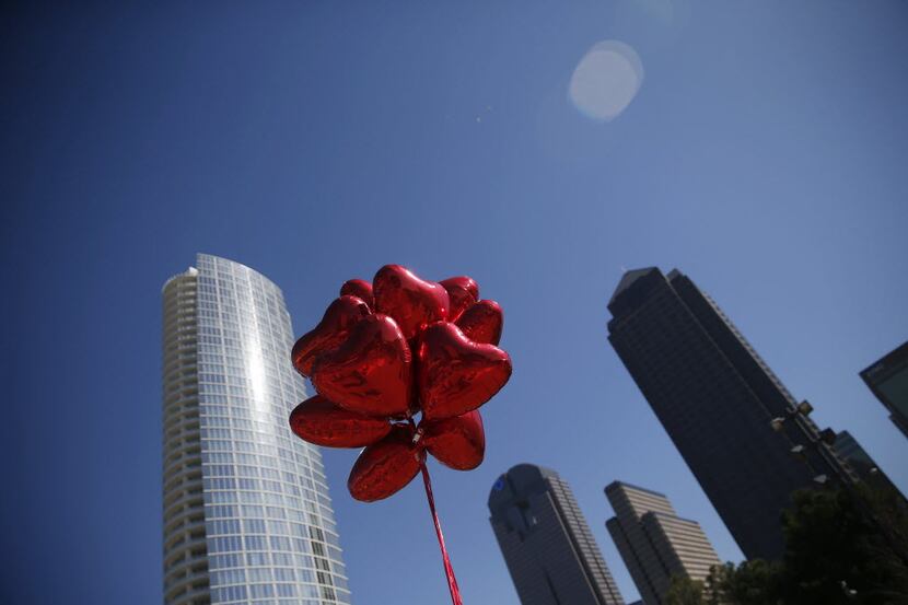 File photo of heart-shaped balloons fly overhead during a "Hearts in the Park" event at...