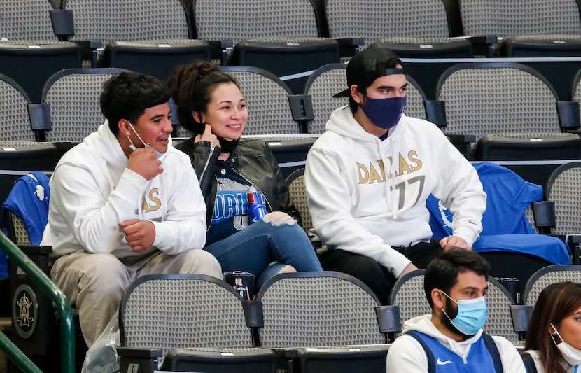 Parkland nurse Heather Lopez, center, watches the Dallas Mavericks take on the Atlanta Hawks...