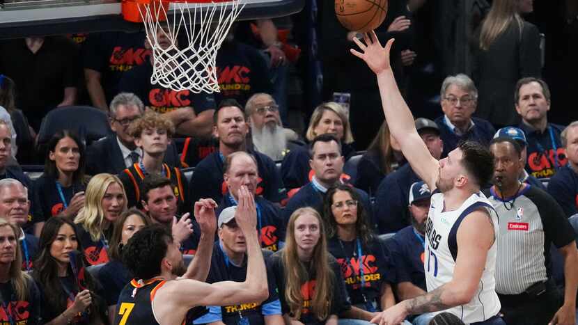 Dallas Mavericks guard Luka Doncic (77) goes for a layup as Oklahoma City Thunder forward Chet Holmgren (7) defends during the first half in Game 5 of an NBA basketball second-round playoff series on Wednesday, May 15, 2024, in Oklahoma City.