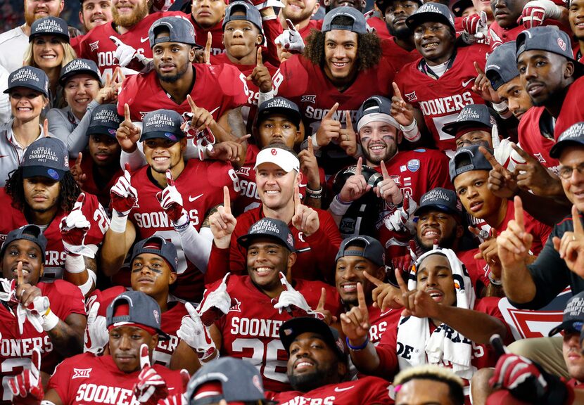 The Oklahoma Sooners football team, including head coach Lincoln Riley (center) and...