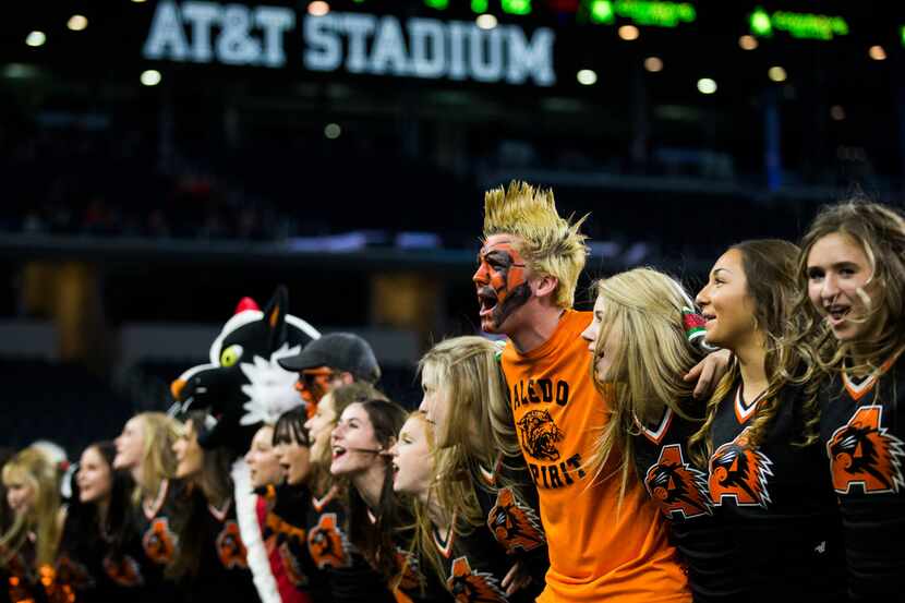 Aledo cheerleaders cheer on the sideline during the fourth quarter of a UIL Class 5A...