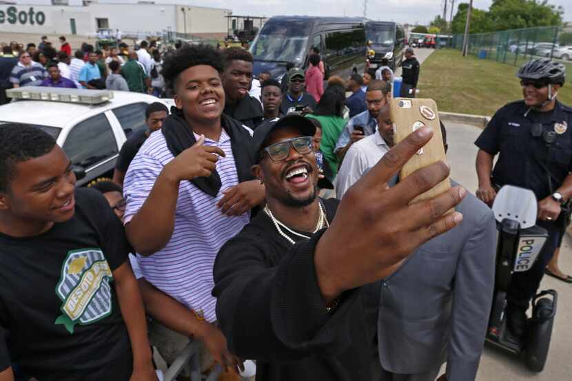 Denver Broncos linebacker Von Miller takes a selfie with fans during Von Miller Day at...