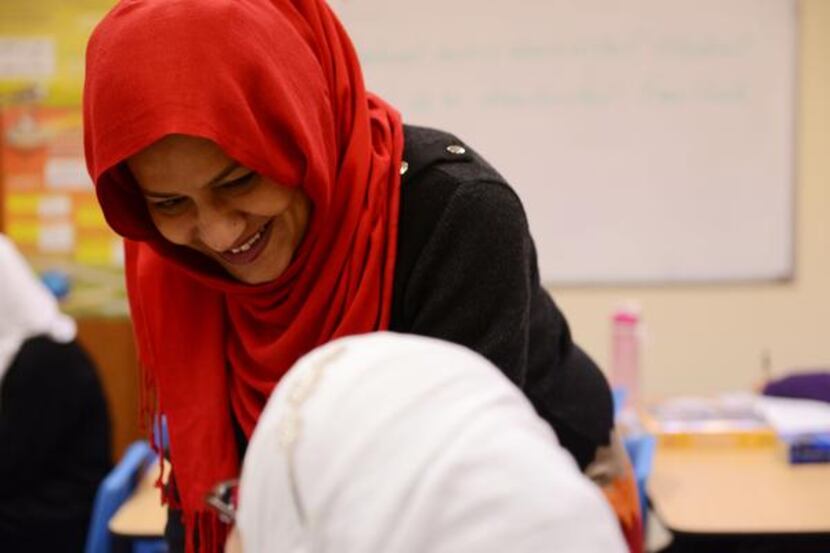 
English teacher Usma Shahi works with a seventh-grader. In January, teachers received STAAR...