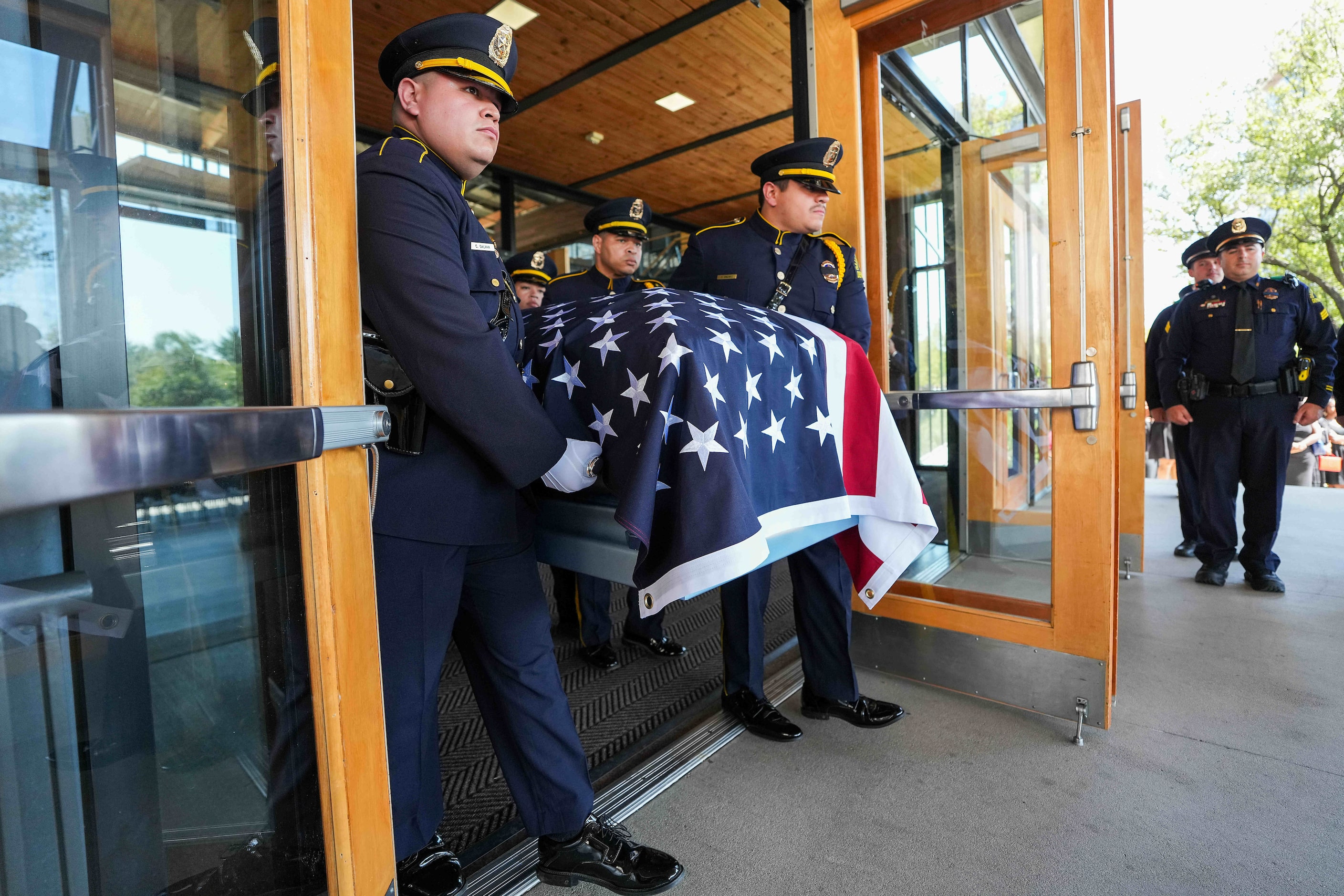 Members of the Dallas Police Honor Guard  carry the casket of officer Darron Burks from the...