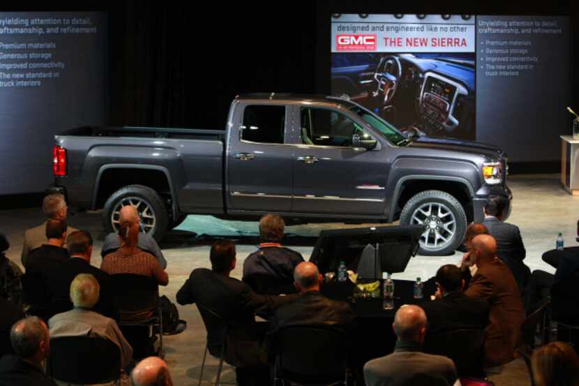 Attendees view the 2014 GMC Sierra during the unveiling of new pickup trucks  in Pontiac,...