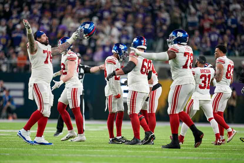New York Giants players celebrate after the Minnesota Vikings failed to get a first down...