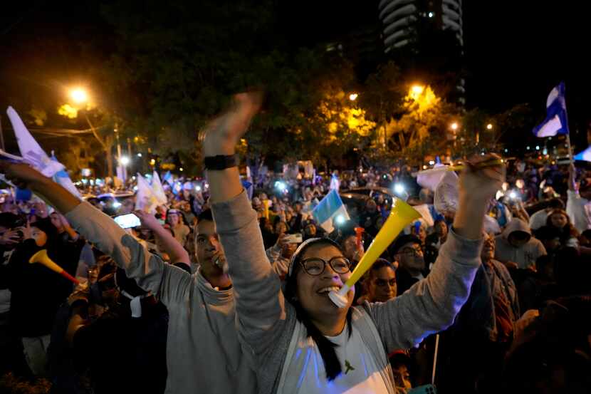 Supporters of presidential candidate Bernardo Arevalo celebrate after preliminary results...