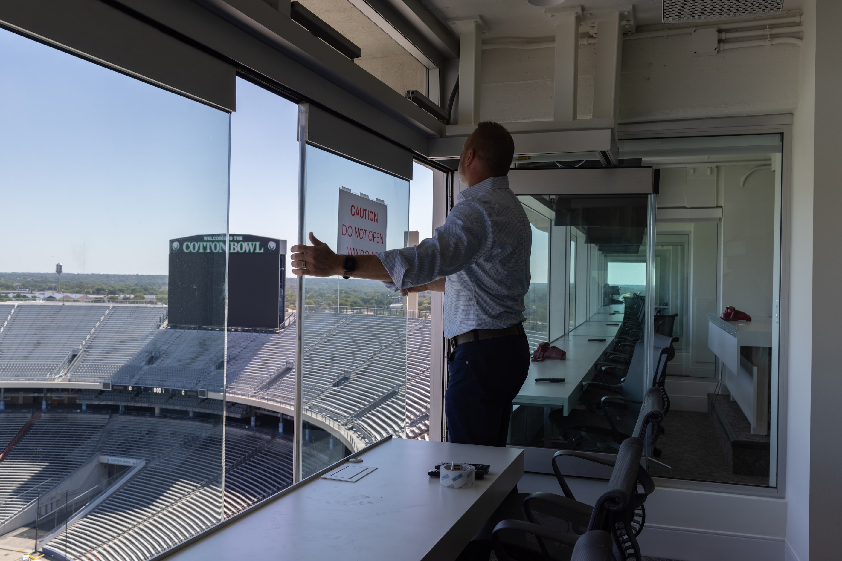 Overland Associate Principal Chad Scheckel demonstrates the sliding windows in the broadcast...