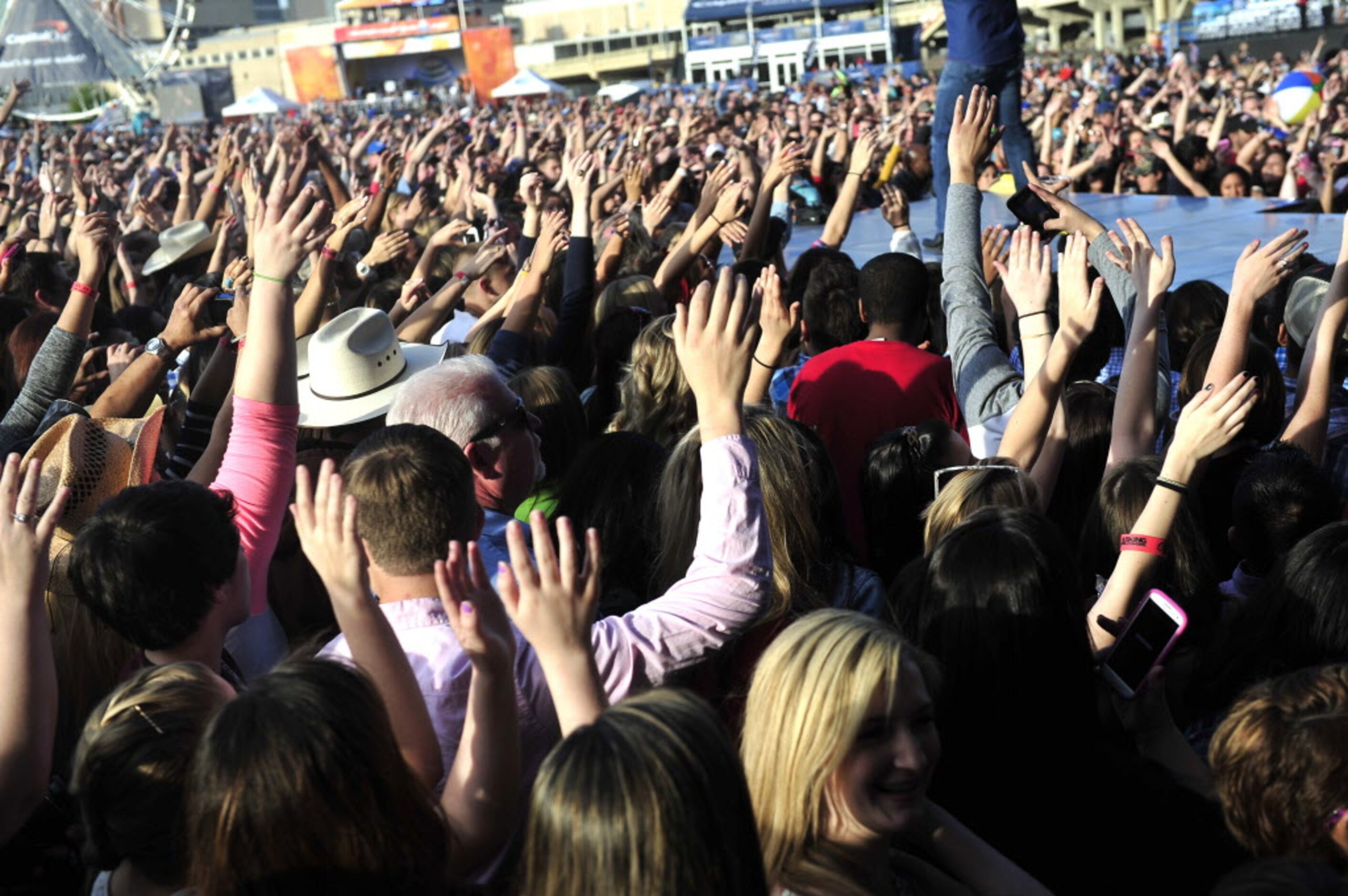 Fans wave their hands as Mike Eli of the Eli Young Band performs onstage at the 2014 NCAA...