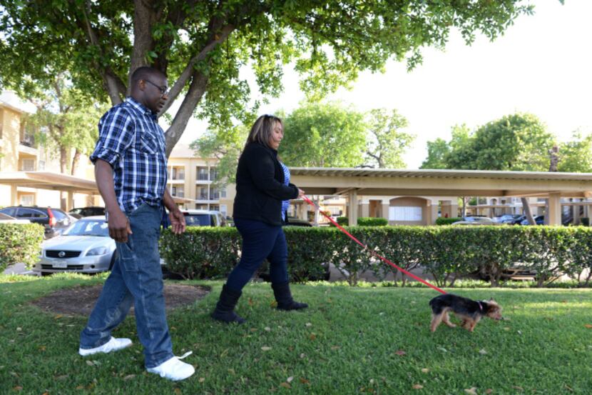 Alex and Billy Stanfield walk their dog Gravy within the Oak Forest apartment complex in...