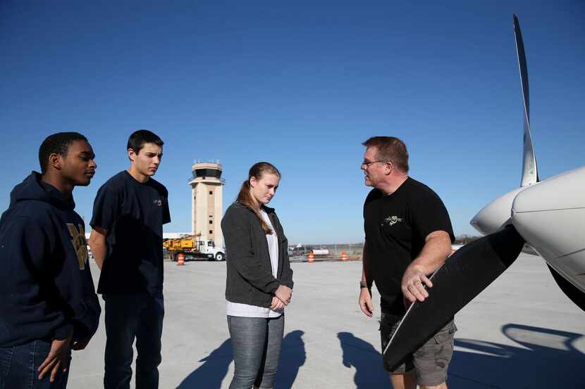 
Aviation mentor Jeff Hanson (right), an American Airlines captain, goes through a preflight...