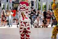 People watch a traditional dragon dance the Asian Heritage Fest at Asia Times Square in...