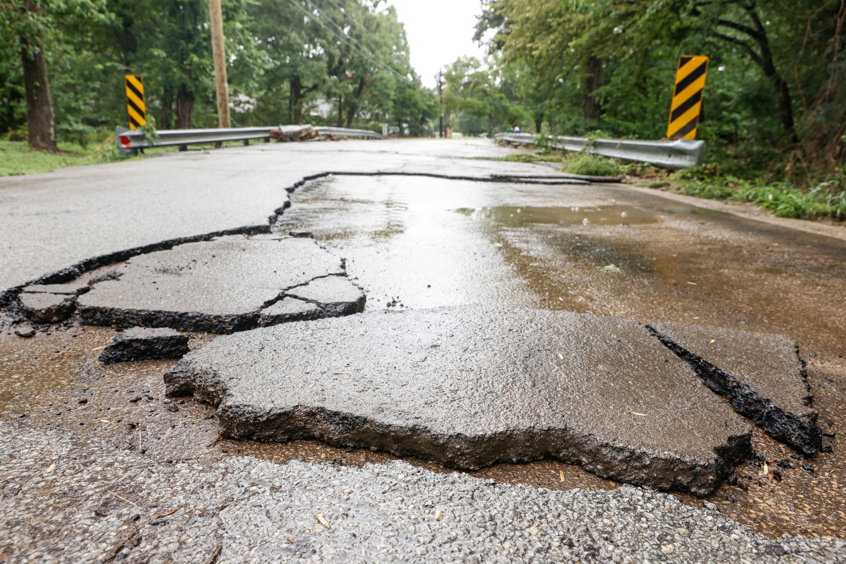 Damaged road remains by a flood-prone neighborhood in Balch Springs, a day after Dallas-Fort...