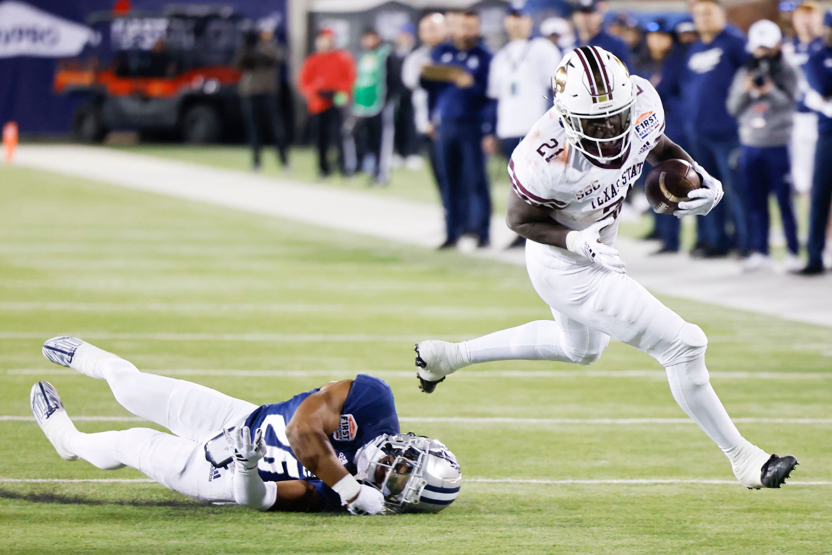 Texas State running back Ismail Mahdi (21) runs past Rice safety Gabriel Taylor (26) towards...