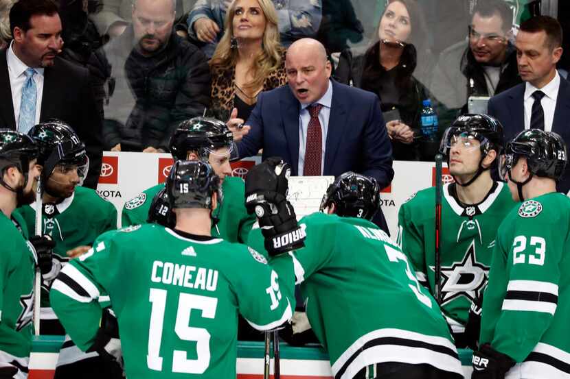 In this Jan. 30, 2019, photo, Dallas Stars head coach Jim Montgomery, center, instructs the...