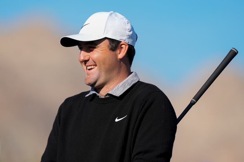 Scottie Scheffler laughs as he waits to tee off on the first hole of the La Quinta Country...