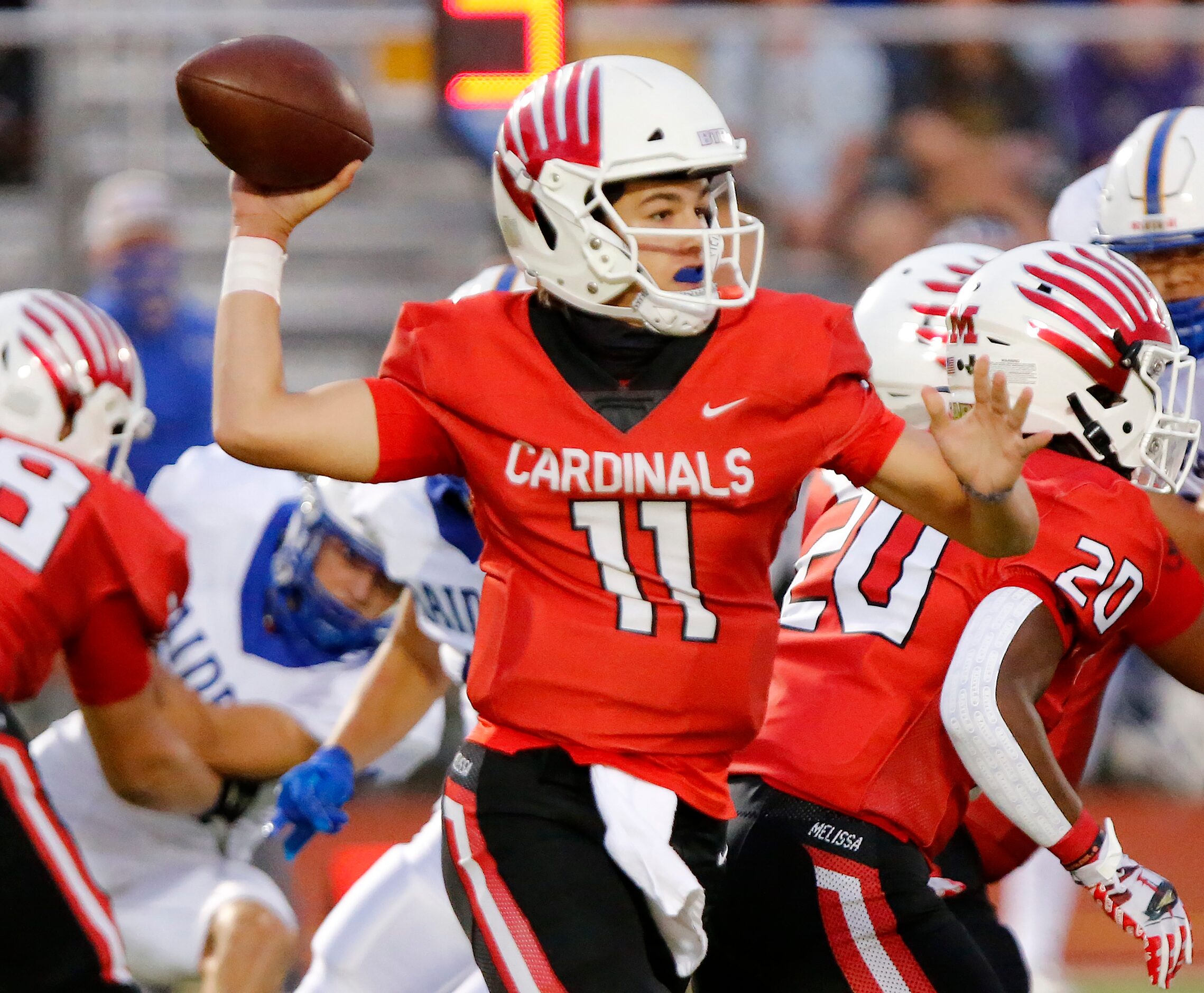 Melissa High School quarterback Sam Fennegan (11) throws a pass during the first half as...