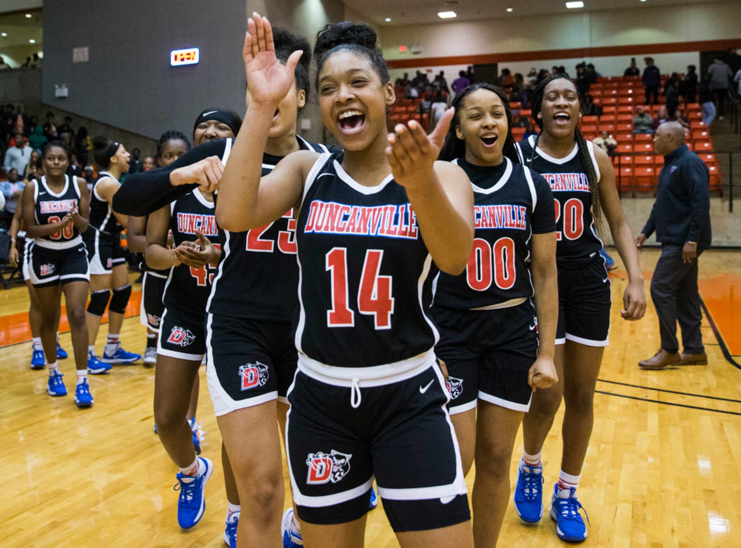 Duncanville's Kiyara Howard (14) and the rest of the team celebrates a 47-43 win after a...