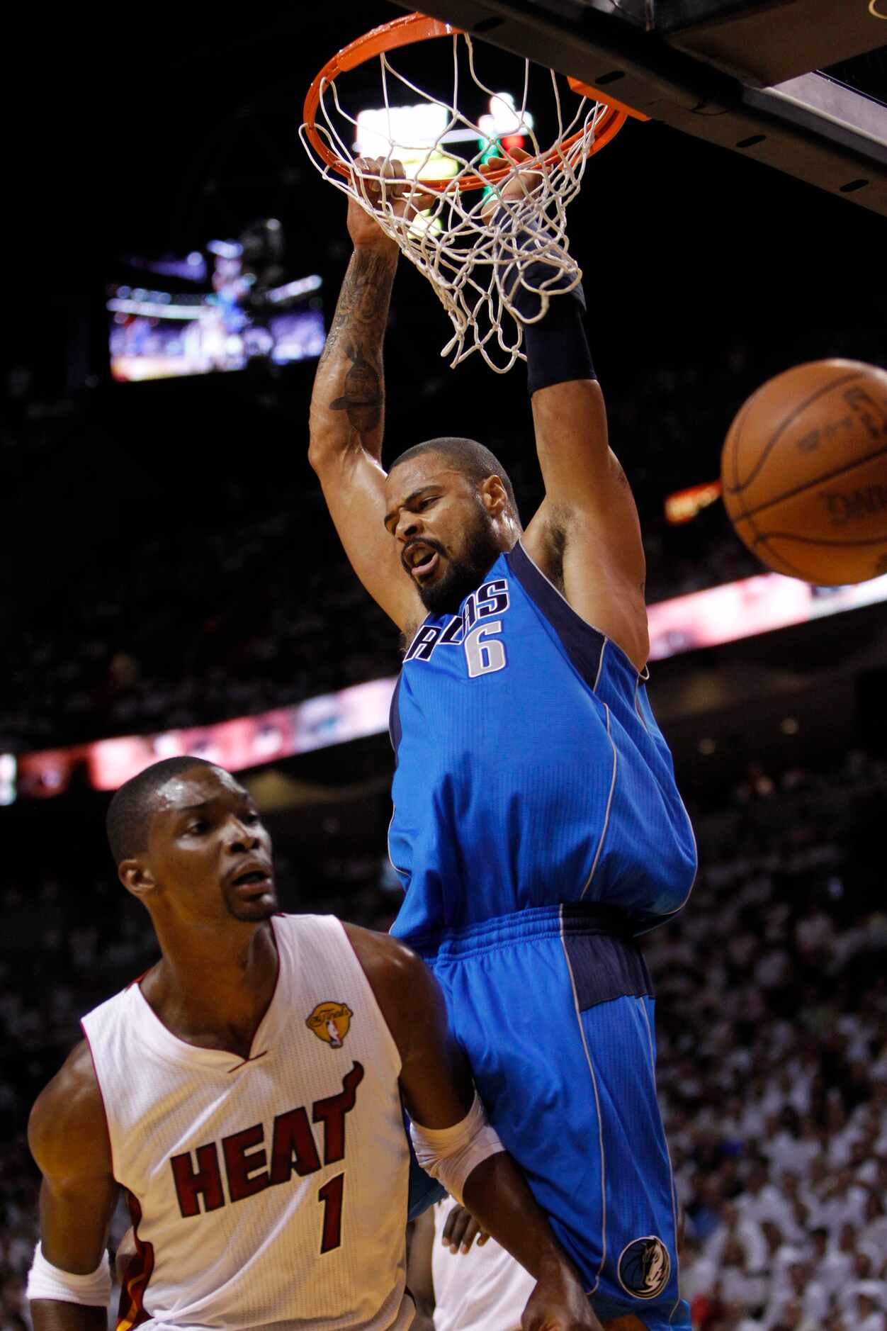 Dallas Mavericks center Tyson Chandler (6) dunks on Miami Heat power forward Chris Bosh (1)...
