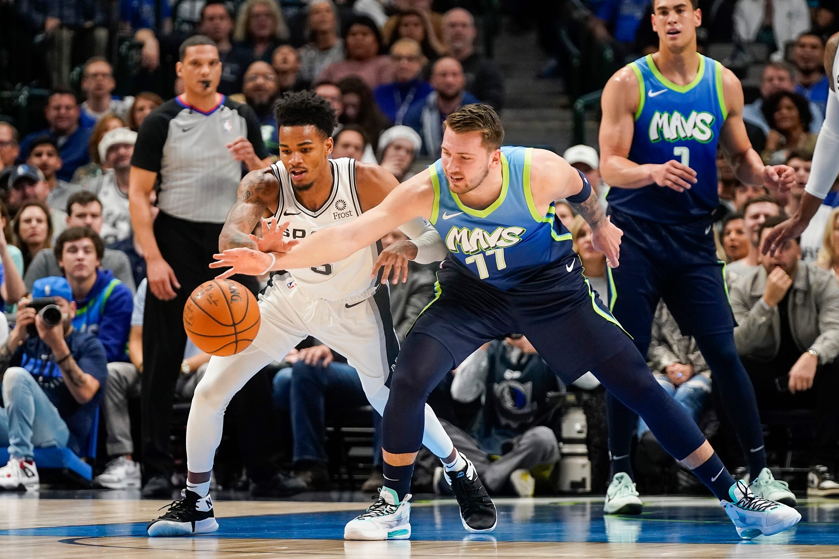 Dallas Mavericks guard Luka Doncic (77) fights for a loose ball with San Antonio Spurs guard...